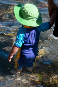 Toddler wearing sun hat and protective clothing
